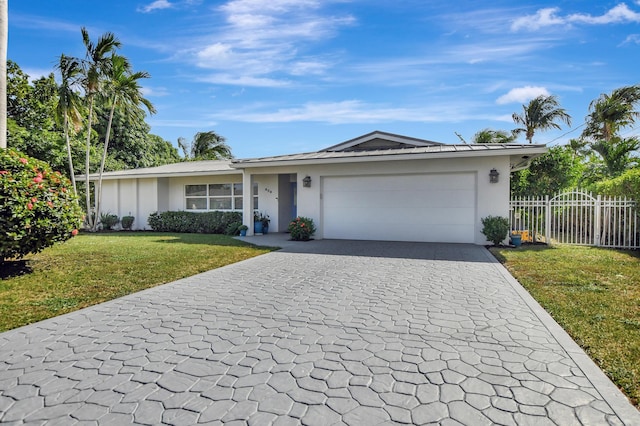 ranch-style house featuring a garage and a front yard