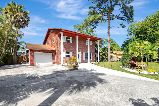 view of front facade featuring a garage and a front lawn