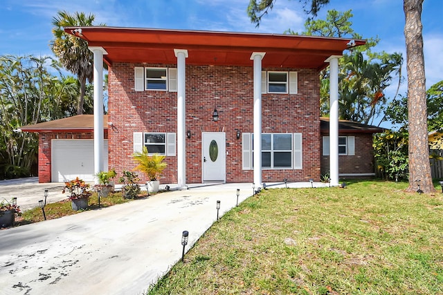 view of front of home featuring a garage and a front lawn