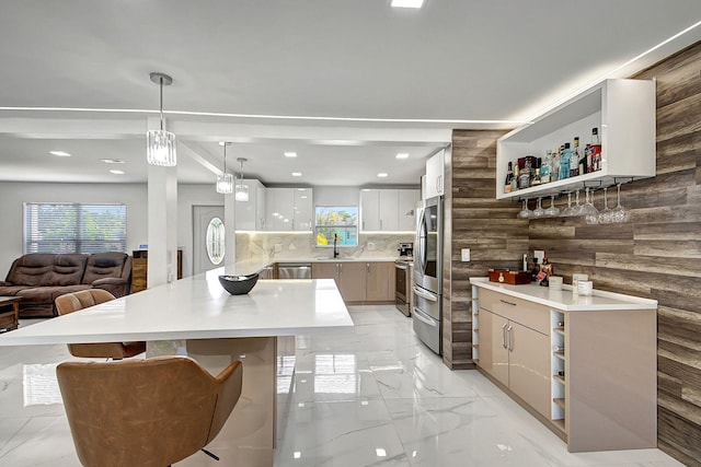 kitchen featuring hanging light fixtures, appliances with stainless steel finishes, and a center island