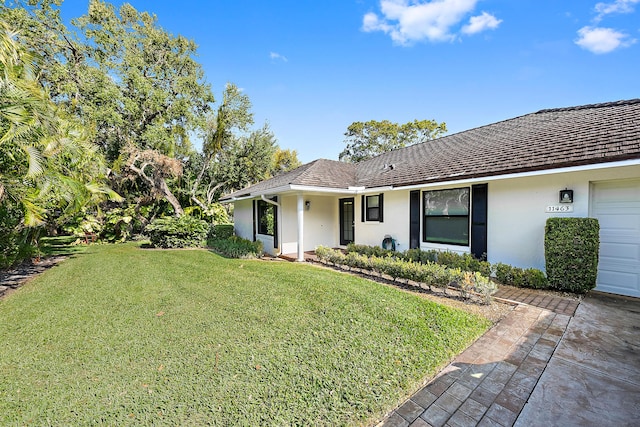 view of front of house featuring a garage and a front yard