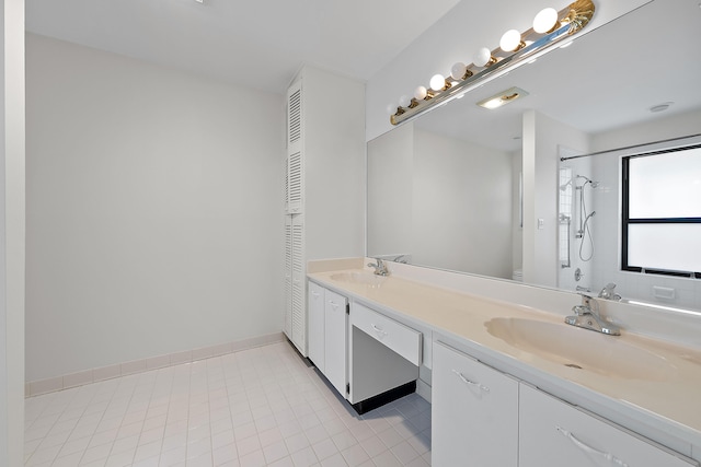 bathroom featuring tiled shower, vanity, toilet, and tile patterned flooring