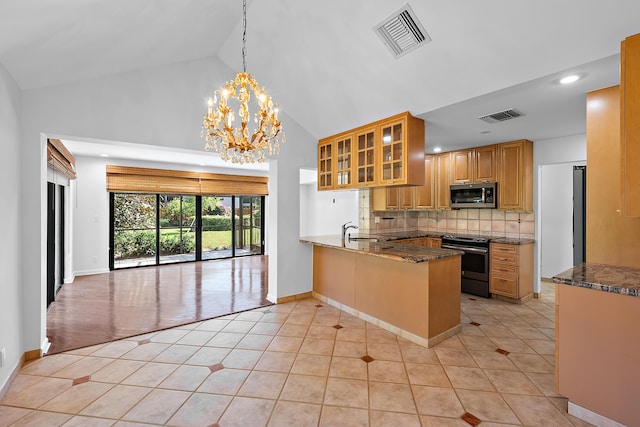 kitchen featuring stainless steel appliances, tasteful backsplash, light tile patterned flooring, decorative light fixtures, and kitchen peninsula