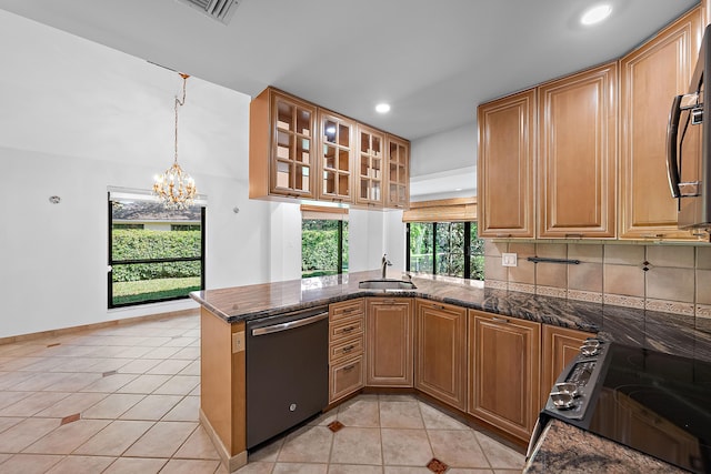 kitchen featuring sink, light tile patterned floors, dishwasher, decorative light fixtures, and kitchen peninsula