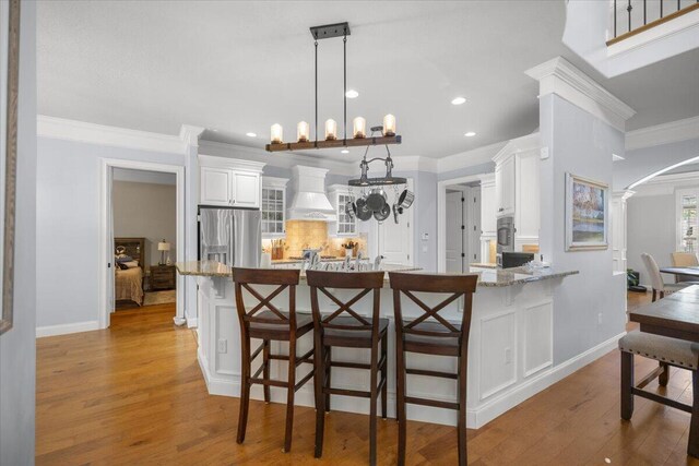 office featuring crown molding, ceiling fan, and light hardwood / wood-style floors