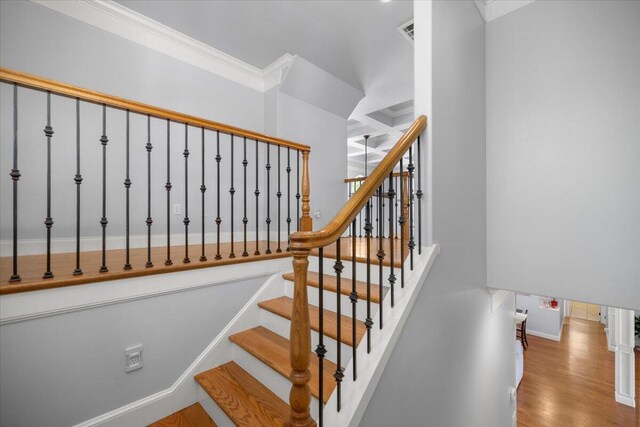 hallway featuring crown molding, coffered ceiling, and hardwood / wood-style floors