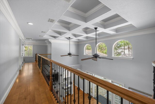 bedroom with crown molding, wood-type flooring, and connected bathroom