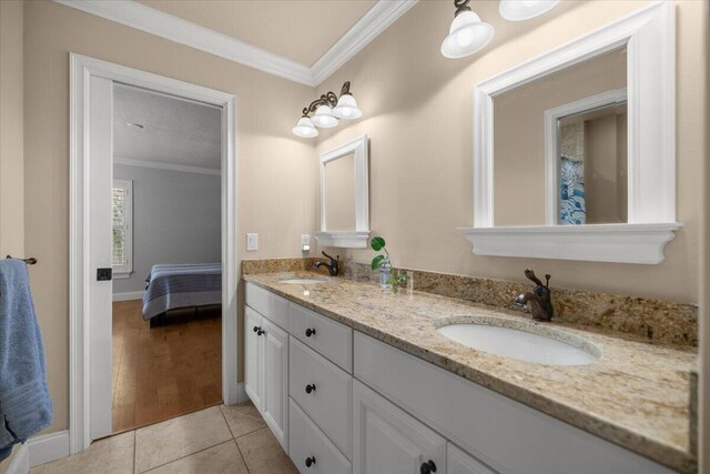 bathroom featuring crown molding, vanity, and tile patterned flooring