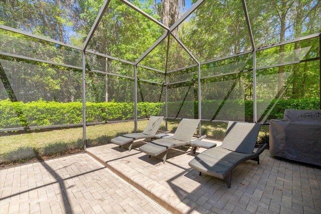 view of pool featuring french doors, a patio, a grill, and glass enclosure