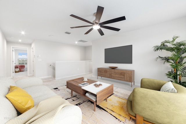 living room with light carpet and ceiling fan