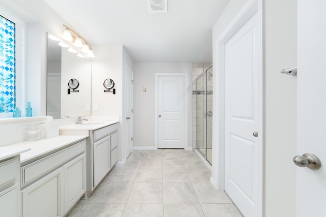 bathroom featuring tile patterned floors, vanity, and a shower with door