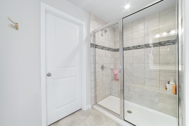 bathroom featuring a shower with shower door and tile patterned floors