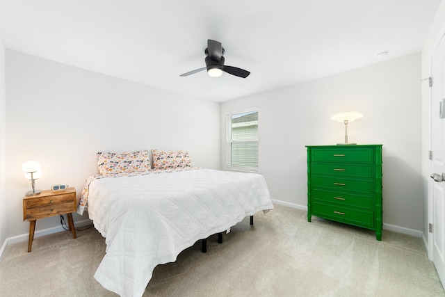 bedroom featuring light carpet and ceiling fan