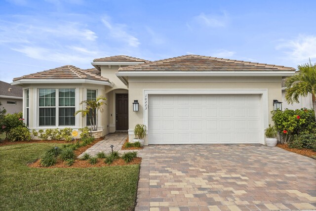 view of front facade with a yard and a garage