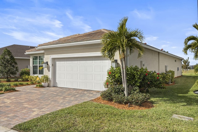 view of front of property featuring a garage and a front lawn