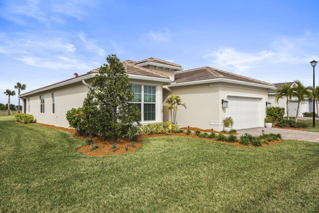 view of front of house with a garage and a front yard