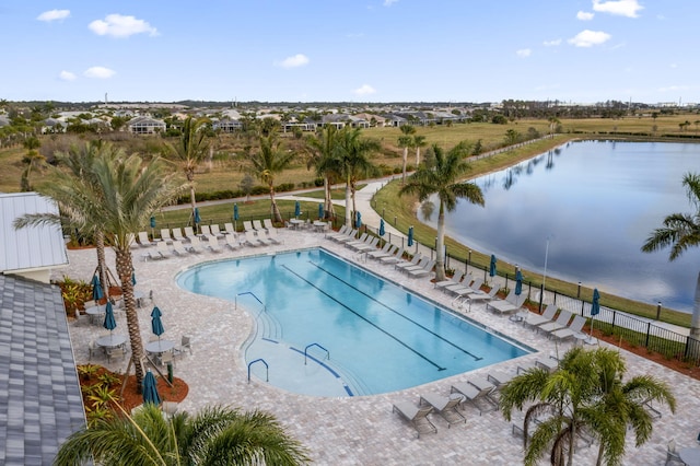 view of pool with a patio and a water view