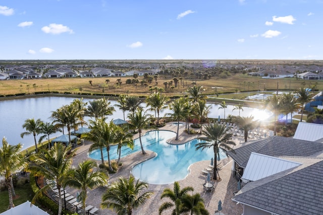 view of swimming pool with a patio and a water view