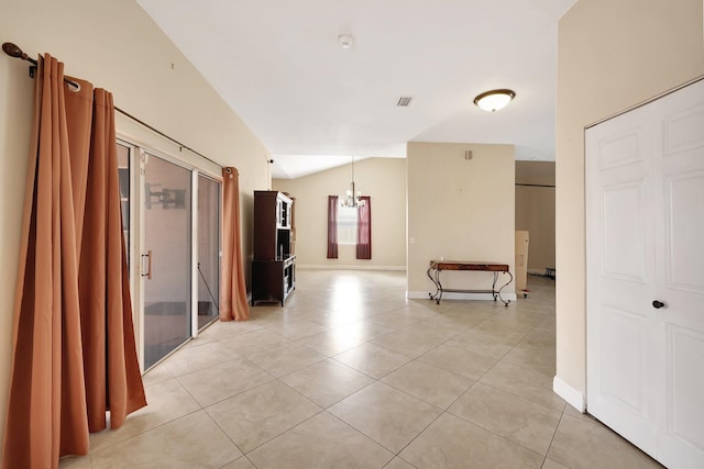 corridor featuring a chandelier, vaulted ceiling, and light tile patterned floors