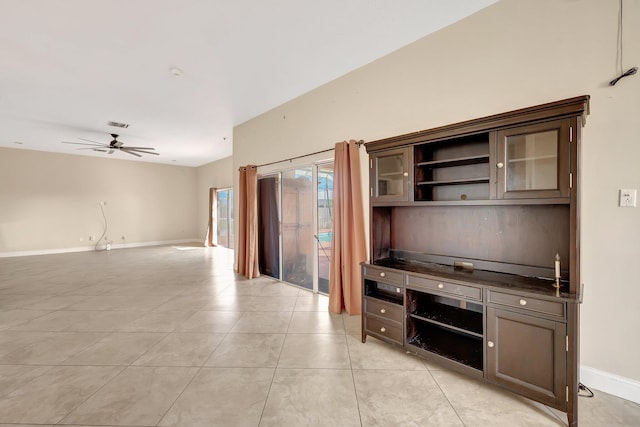 kitchen featuring ceiling fan, light tile patterned floors, and dark brown cabinetry