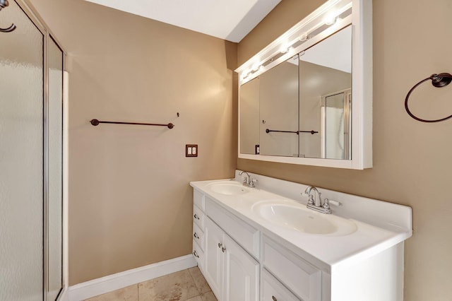 bathroom featuring tile patterned flooring, vanity, and walk in shower