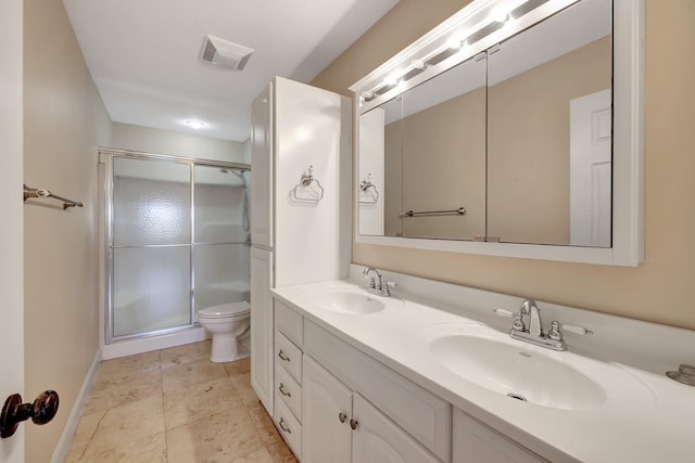 bathroom with walk in shower, vanity, and toilet