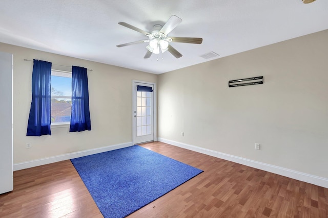 empty room featuring wood-type flooring and ceiling fan