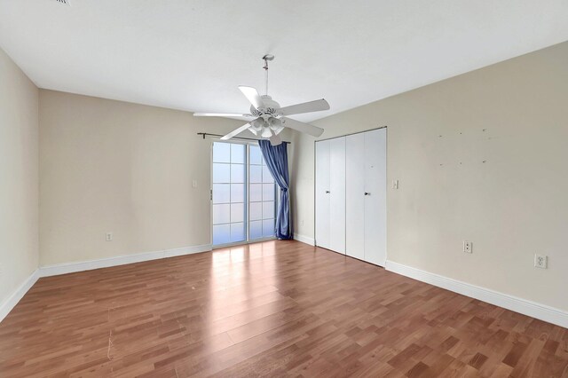 empty room featuring wood-type flooring and ceiling fan