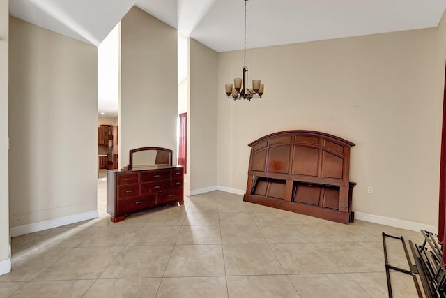 tiled bedroom with an inviting chandelier and vaulted ceiling