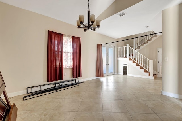 tiled entryway with an inviting chandelier