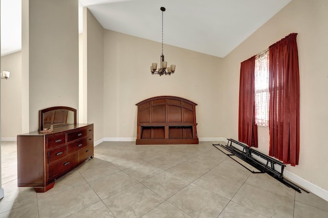 tiled foyer with lofted ceiling and a notable chandelier