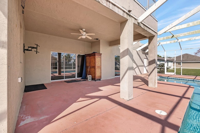 view of patio featuring a lanai and ceiling fan