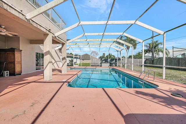 view of swimming pool with a patio and glass enclosure