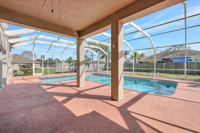 view of swimming pool featuring a patio and a lanai