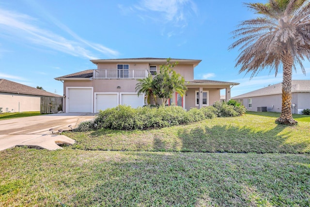 view of front of house with a balcony, a garage, a front lawn, and central air condition unit