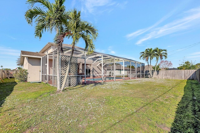 view of yard featuring a fenced in pool and a lanai