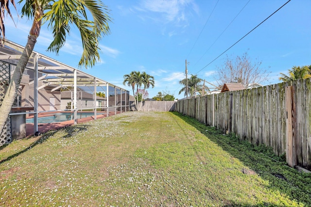 view of yard featuring a fenced in pool and a lanai