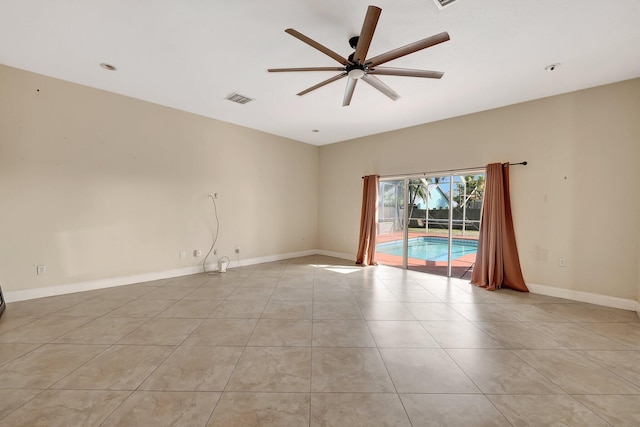 tiled empty room featuring ceiling fan