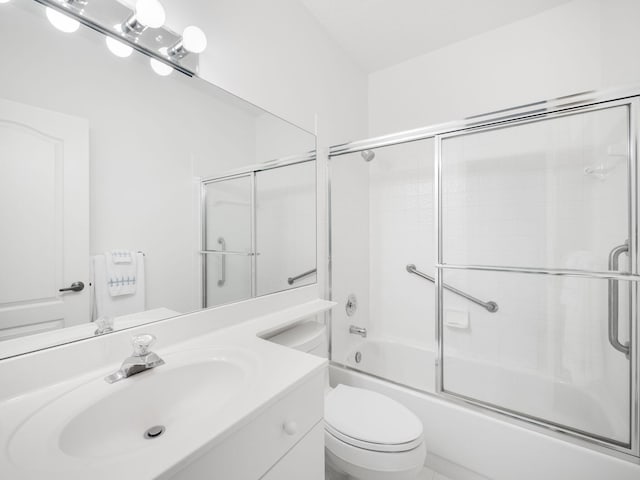 full bathroom with vanity, combined bath / shower with glass door, and toilet