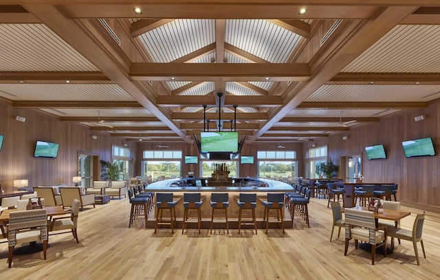 dining room featuring coffered ceiling, a healthy amount of sunlight, and beam ceiling