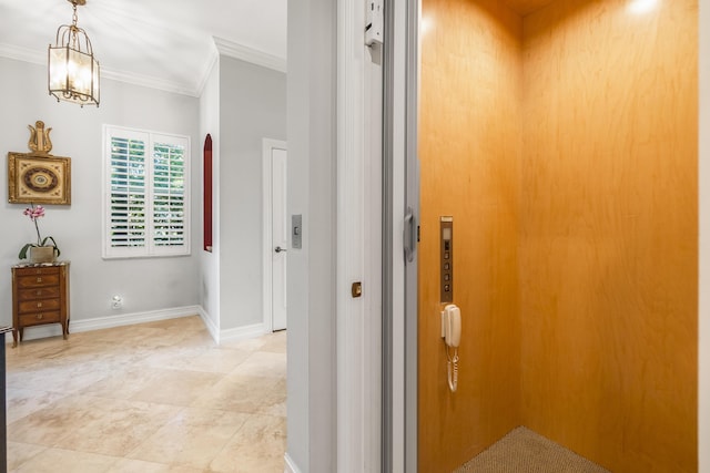 hall with crown molding, elevator, and a chandelier