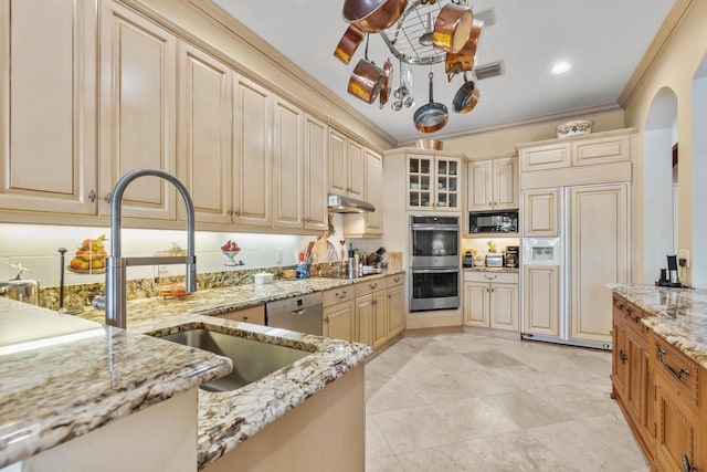 kitchen featuring sink, ornamental molding, light tile patterned floors, light stone counters, and black appliances