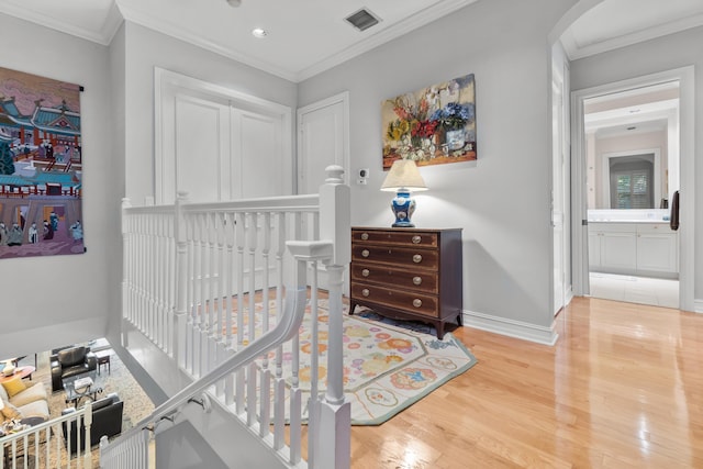 bedroom with crown molding, a closet, and hardwood / wood-style flooring