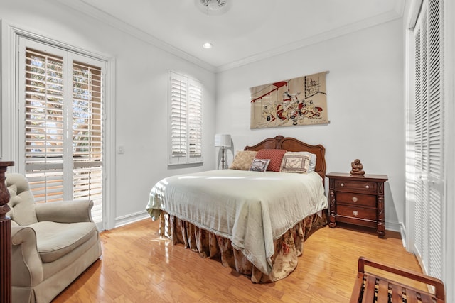 bedroom with crown molding, access to exterior, and hardwood / wood-style floors