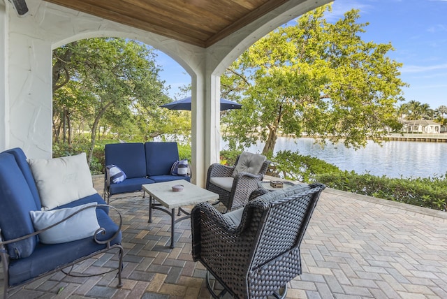 view of patio with a water view and outdoor lounge area