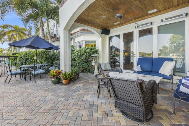 view of patio / terrace with outdoor lounge area, ceiling fan, and french doors