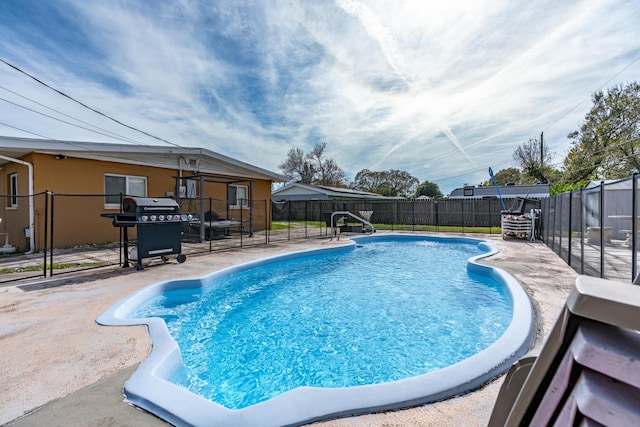 view of pool featuring grilling area, a patio area, a fenced in pool, and a fenced backyard