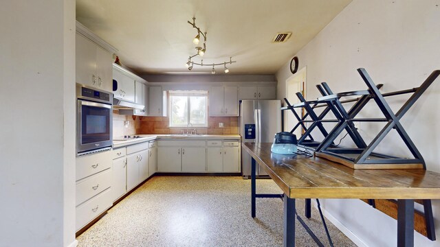 kitchen with backsplash, stainless steel appliances, sink, and white cabinets