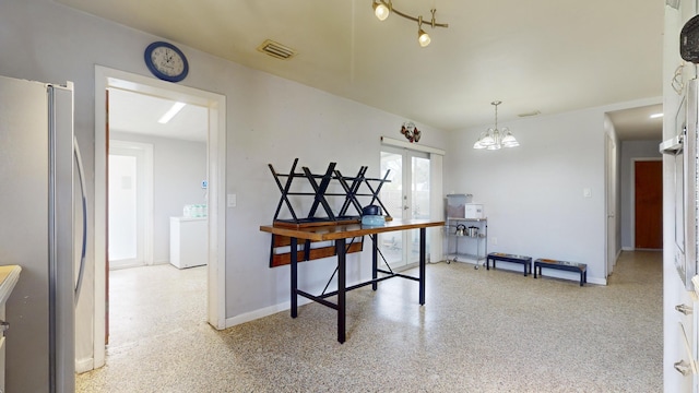 dining area featuring speckled floor, visible vents, washer / dryer, baseboards, and a notable chandelier
