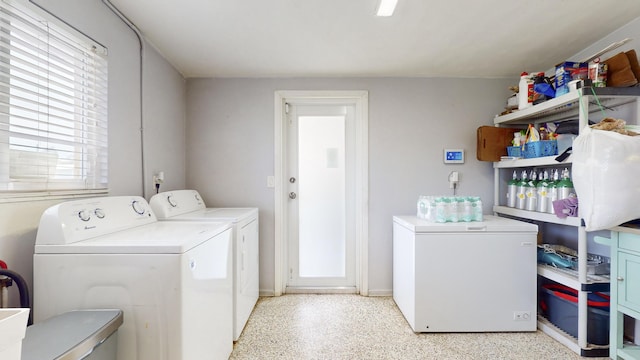 laundry room with washing machine and clothes dryer and laundry area